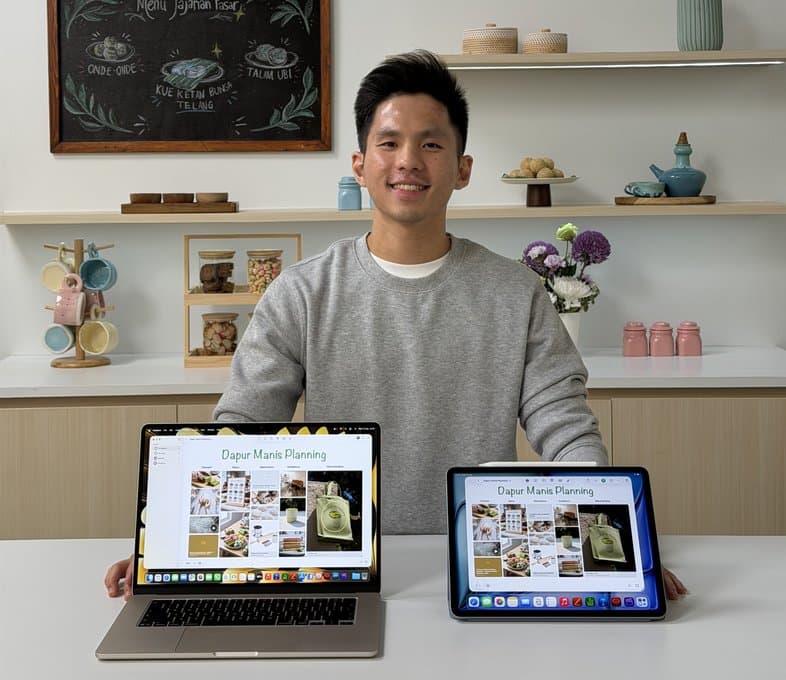 Edward at a desk with a laptop and tablet showing design work