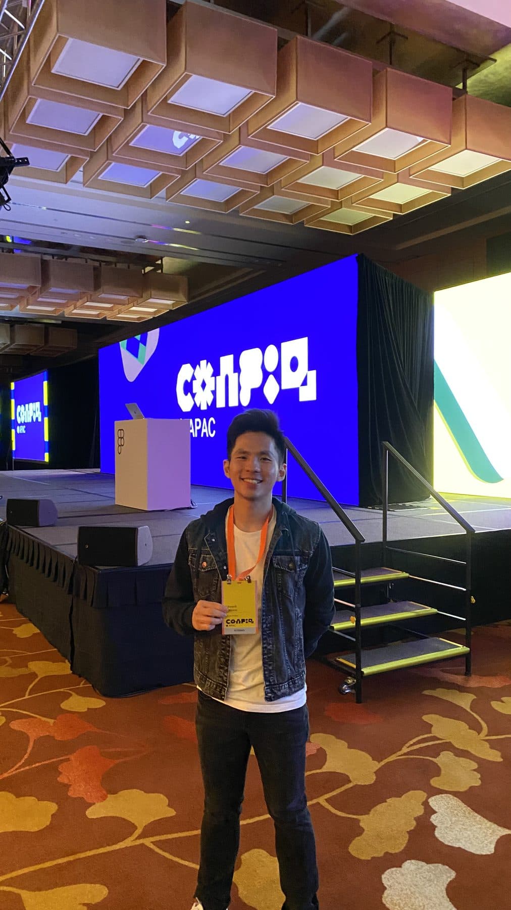 Edward standing at a conference with a Logitech presentation behind him