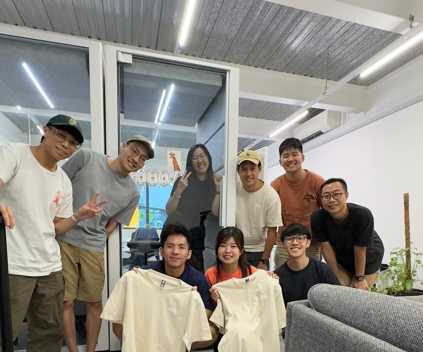 Edward and friends with merch tees in the office